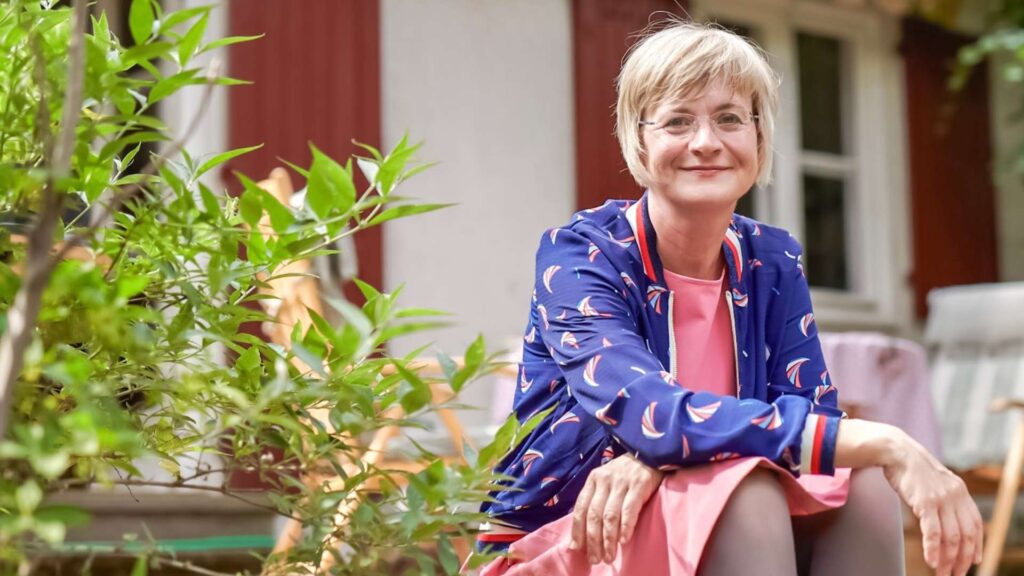 Astrid Zand im Garten sitzend